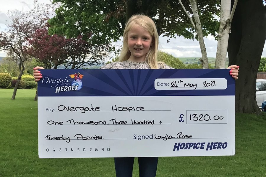 Layla Rose holding a cheque of the money she raised for Overgate